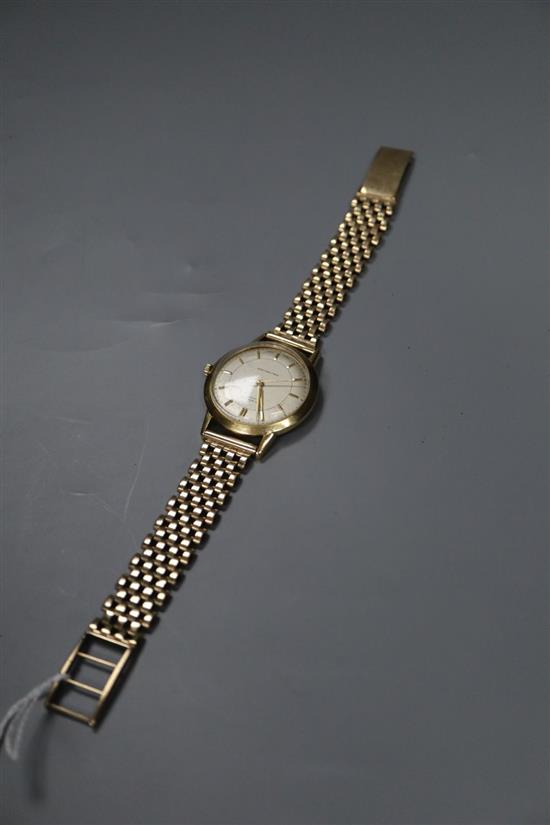 A gentlemans 18ct gold manual wind wrist watch, retailed by J.W. Benson, on a 9ct gold bracelet, gross 49.7 grams.